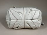 an image of a white purse on a table