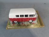 a small red and white bus on a clear tray