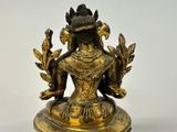 an image of a statue of a woman sitting on top of a table