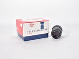 a close up of a camera lens in a box on a white surface