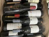 many bottles of wine in a cardboard box on the floor
