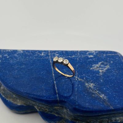 an image of a diamond ring sitting on top of a blue stone