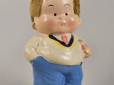 a small figurine of a boy with a tie on