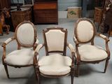 four chairs in a room with a lot of furniture in the background