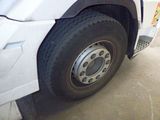 a white truck with a flat tire parked in a parking lot