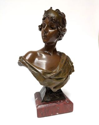 a bronze bust of a woman on a marble base