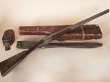 a gun, a knife, and a book on a table
