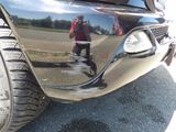 a reflection of a man taking a picture of himself in the side mirror of a car