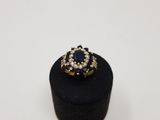 a close up of a ring on a black box with a white background