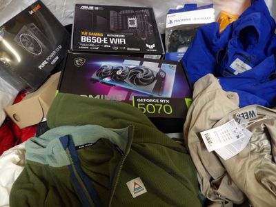 a pile of assorted items that include a computer and a laptop