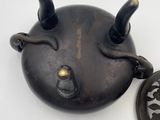 a tea pot with a tea strainer attached to it