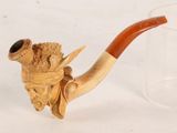 a small pipe with a wooden handle on a table
