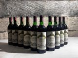 several bottles of wine are lined up in a row on a table