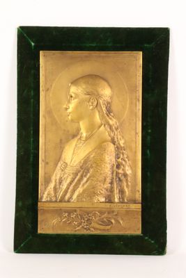 portrait of a woman in gold on a green velvet frame