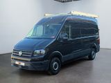 the black van is parked in a large room with white walls