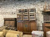 a lot of furniture in a room with a brick wall
