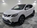 the white nissan qx sport suv is parked in the garage