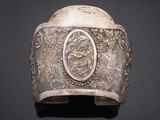 a silver bracelet with a picture of a man and woman on it