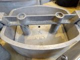 a metal bowl with a screw in it on a table