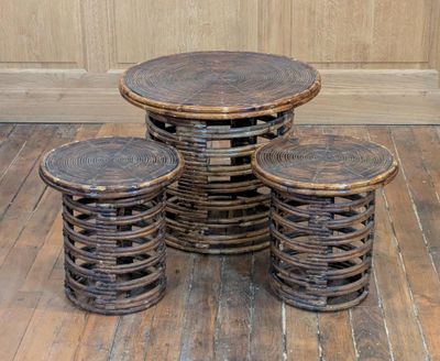 four stools and a table on a wooden floor