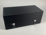 a black box sitting on top of a white table next to a pair of scissors