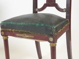 a chair with a green upholstered seat on it