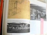 an open book with a picture of a train station in it