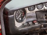 a close up of a car dashboard with various gauges and controls