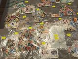 a lot of stamps on a table with stickers on it