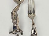 a fork and a spoon sitting next to each other on a table