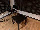 two chairs and a table in the corner of a room
