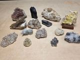 many different kinds of rocks and crystals on a table