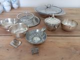 a table with a lot of silver items on it