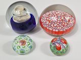 several different colored glass balls sitting next to each other on a white surface