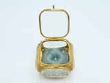 a gold case with a clock inside of it