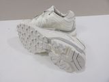 pair of white sneakers on a white surface with a white background