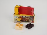 a toy truck and a box of pills on a white surface