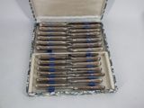 a box with a bunch of pens in it on a table