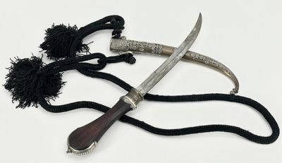 two different types of knives on a white surface