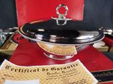 a silver plate with a certificate on it on a table