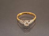a close up of a diamond ring on a table