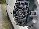 a white van with a fan attached to the side of it