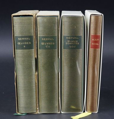 three books are stacked on top of each other on a black surface