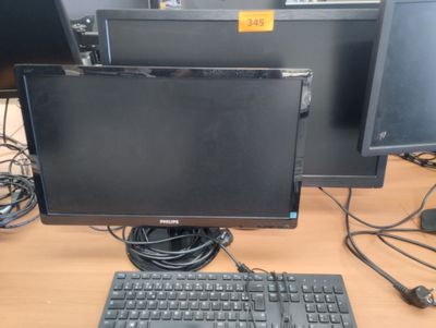 two monitors and a keyboard on the desk