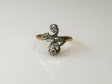 a close up of a gold and silver ring on a white surface