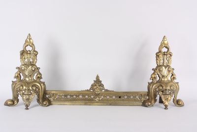 a gold metal shelf with a clock on top of it