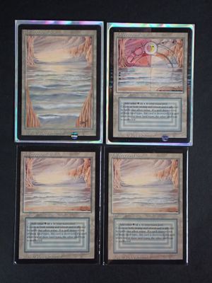 three decks of a card game are shown on a black surface