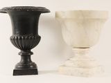 two vases sitting next to each other on a white surface
