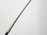 a close up of a violin bow on a white surface