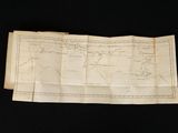 an old map on a black table with a black background